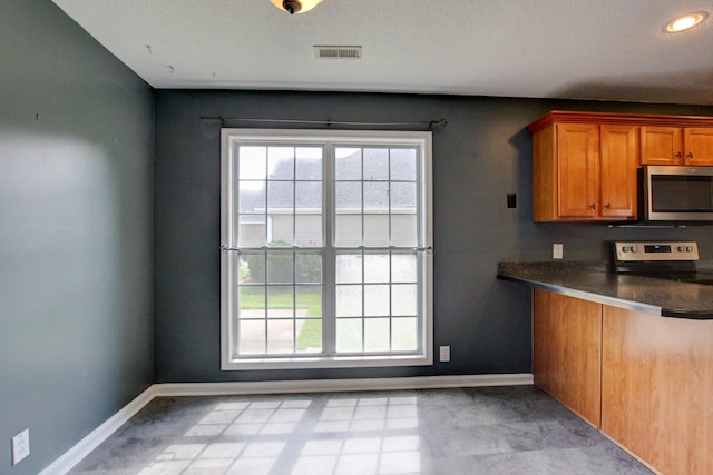4425 Taylor Hall Ln, Adams, TN 37010 - kitchen with appliances with stainless steel finishes, dark countertops, and brown cabinetry
