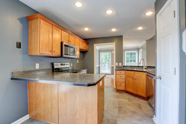 4425 Taylor Hall Ln, Adams, TN 37010 - kitchen with appliances with stainless steel finishes, a peninsula, dark countertops, recessed lighting, and a textured ceiling