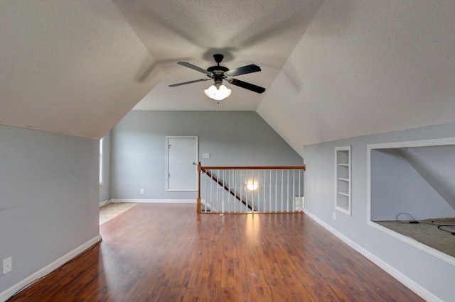 4425 Taylor Hall Ln, Adams, TN 37010 - bonus room with built in shelves, lofted ceiling, ceiling fan, wood finished floors, and a textured ceiling