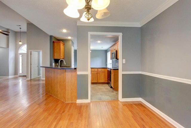 4425 Taylor Hall Ln, Adams, TN 37010 - kitchen with appliances with stainless steel finishes, plenty of natural light, dark countertops, a chandelier, and crown molding