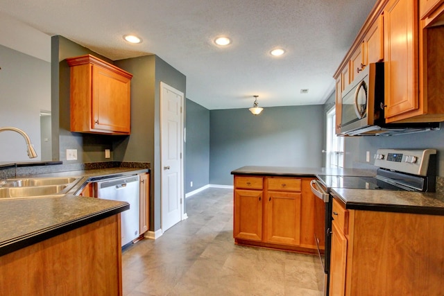 4425 Taylor Hall Ln, Adams, TN 37010 - kitchen with appliances with stainless steel finishes, a peninsula, dark countertops, brown cabinetry, and recessed lighting