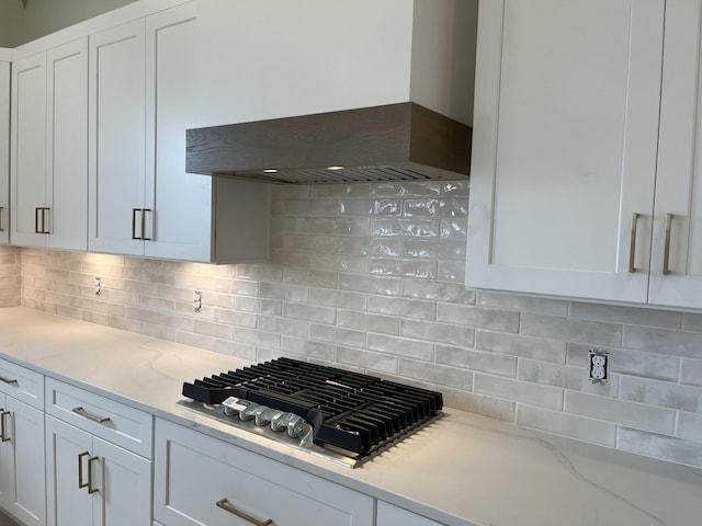 133 Scarsdale Dr S, Hendersonville, TN 37075 - kitchen with wall chimney exhaust hood, stainless steel gas cooktop, white cabinetry, decorative backsplash, and light stone countertops