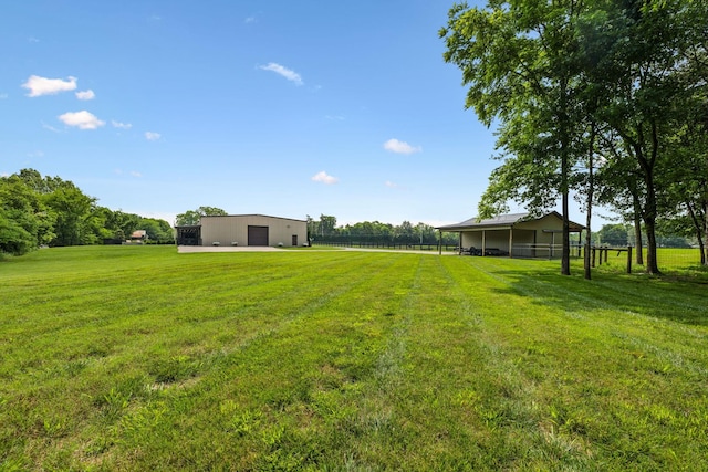 4934 Reynolds Rd, Columbia, TN 38401 - view of green lawn featuring a detached garage, a pole building, an outbuilding, and a rural view