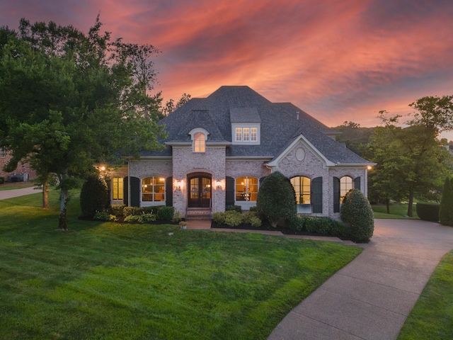 9516 Wicklow Rd, Brentwood, TN 37027 - french country style house featuring french doors, a front yard, brick siding, and a shingled roof
