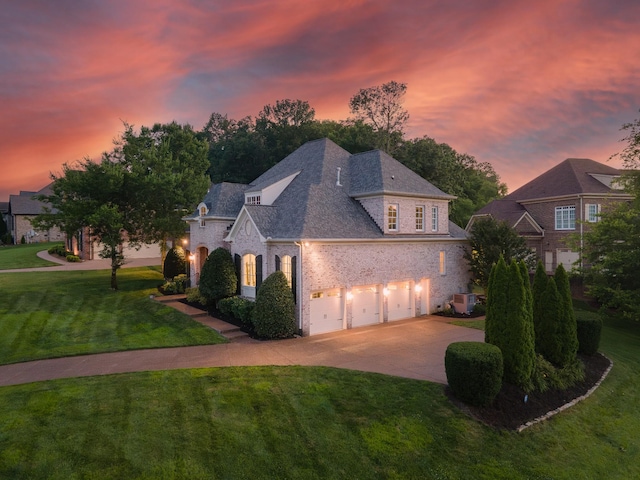 9516 Wicklow Rd, Brentwood, TN 37027 - french country style house featuring brick siding, concrete driveway, a garage, and a front yard