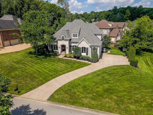 9516 Wicklow Rd, Brentwood, TN 37027 - french country home with a front yard, stone siding, and brick siding