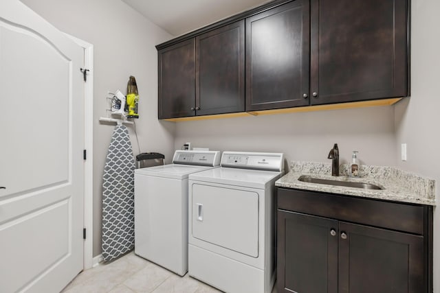 679 Overton Way, Spring Hill, TN 37174 - laundry area featuring cabinet space, washing machine and dryer, and light tile patterned floors
