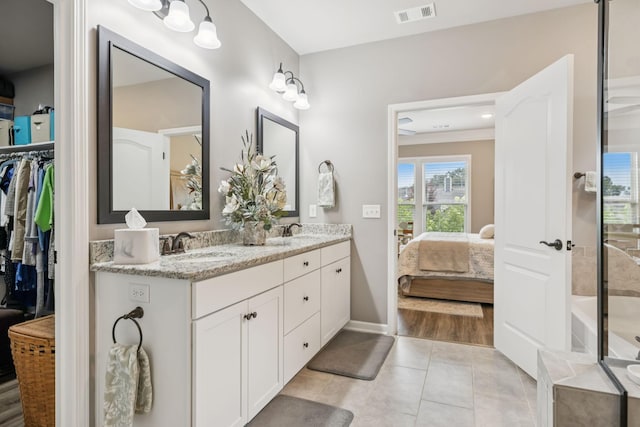 679 Overton Way, Spring Hill, TN 37174 - full bathroom with ensuite bath, double vanity, tile patterned flooring, and a walk in closet