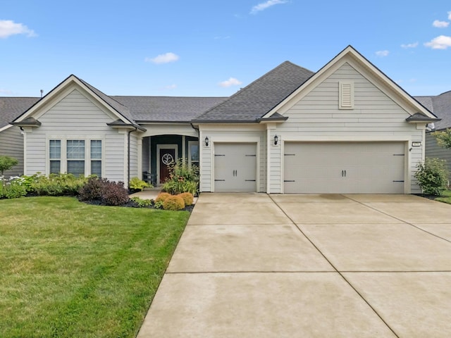 679 Overton Way, Spring Hill, TN 37174 - view of front of property featuring an attached garage, driveway, a front yard, and roof with shingles