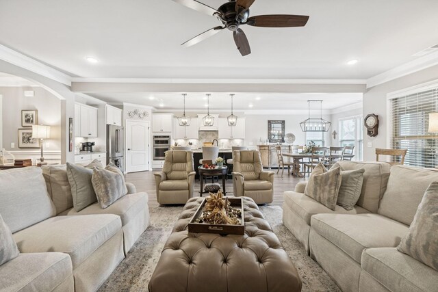679 Overton Way, Spring Hill, TN 37174 - living room with ceiling fan, recessed lighting, light wood-style flooring, arched walkways, and crown molding