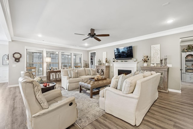 679 Overton Way, Spring Hill, TN 37174 - living room featuring a ceiling fan, wood finished floors, crown molding, recessed lighting, and a lit fireplace