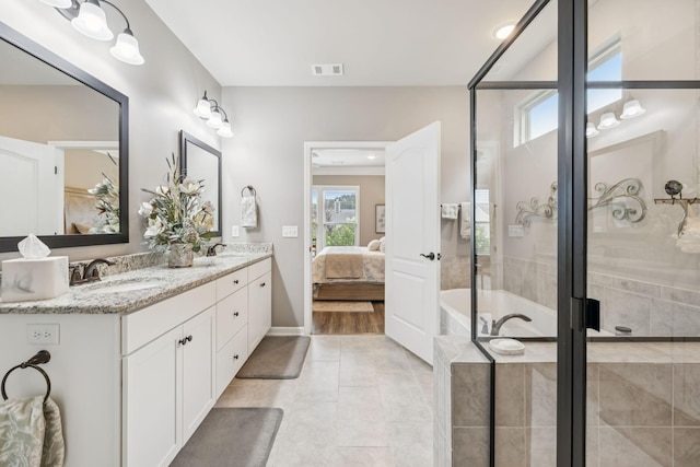 679 Overton Way, Spring Hill, TN 37174 - ensuite bathroom with double vanity, a garden tub, tile patterned floors, and a stall shower