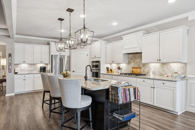 679 Overton Way, Spring Hill, TN 37174 - kitchen featuring appliances with stainless steel finishes, recessed lighting, custom exhaust hood, tasteful backsplash, and wood finished floors
