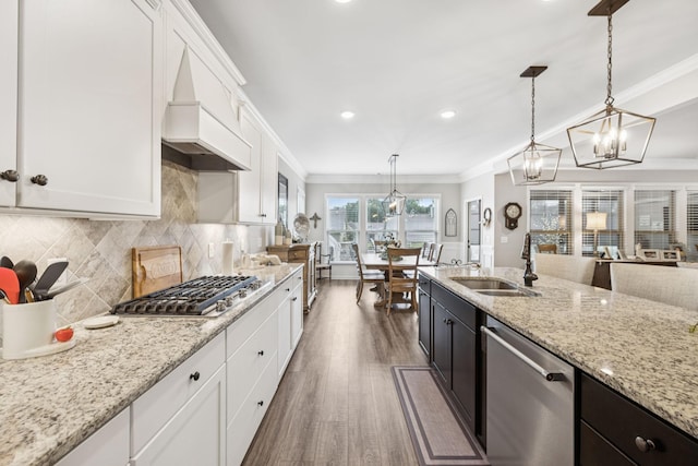679 Overton Way, Spring Hill, TN 37174 - kitchen featuring appliances with stainless steel finishes, ornamental molding, wood finished floors, white cabinetry, and pendant lighting