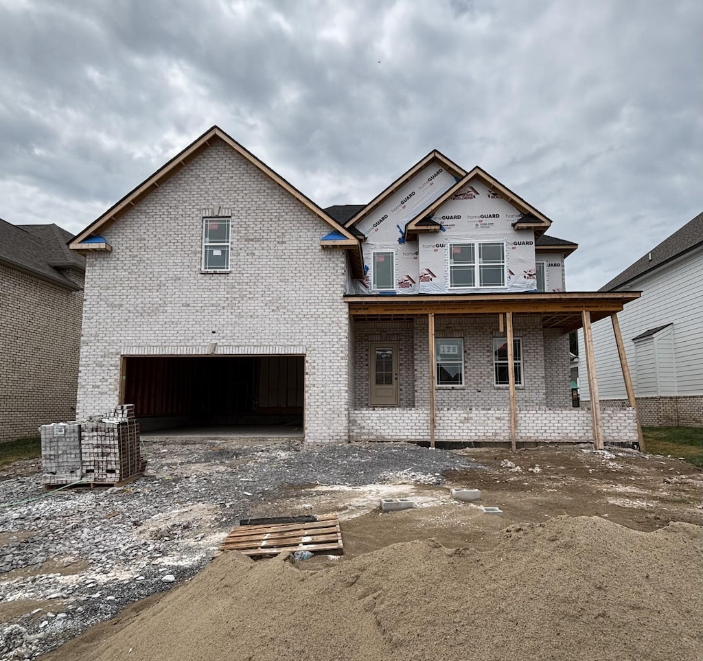474 Spiderwort Dr, Clarksville, TN 37043 - view of front of house featuring brick siding, covered porch, and a garage