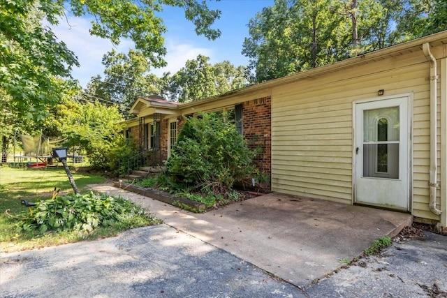 106 Ulcer Hollow Rd, Waverly, TN 37185 - property entrance featuring a patio and brick siding