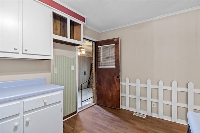 106 Ulcer Hollow Rd, Waverly, TN 37185 - kitchen with dark wood-style flooring, light countertops, white cabinetry, crown molding, and ceiling fan