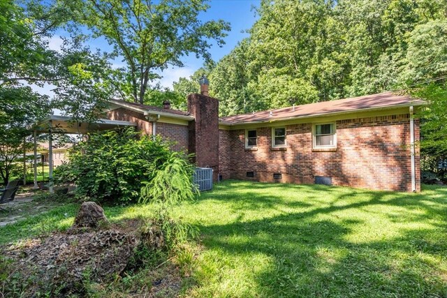 106 Ulcer Hollow Rd, Waverly, TN 37185 - back of house with a chimney, a yard, brick siding, and crawl space