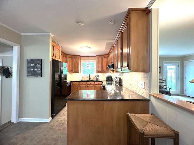 412 Winwood Dr, Lebanon, TN 37087 - kitchen featuring black fridge, range with electric stovetop, a peninsula, dark countertops, and decorative backsplash