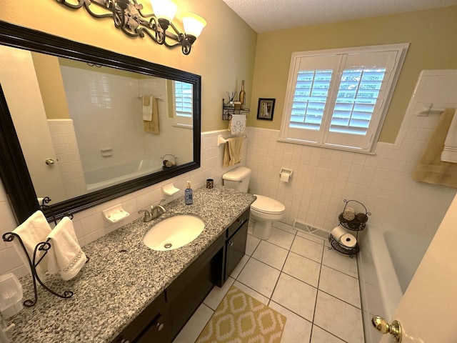 412 Winwood Dr, Lebanon, TN 37087 - full bath featuring vanity, tile patterned floors, wainscoting, tile walls, and a textured ceiling