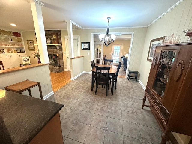 412 Winwood Dr, Lebanon, TN 37087 - dining space with crown molding, a brick fireplace, a chandelier, and tile patterned flooring