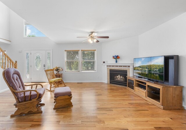 3899 Sadlersville Rd, Adams, TN 37010 - living room with a ceiling fan, a fireplace with flush hearth, light wood finished floors, and stairway