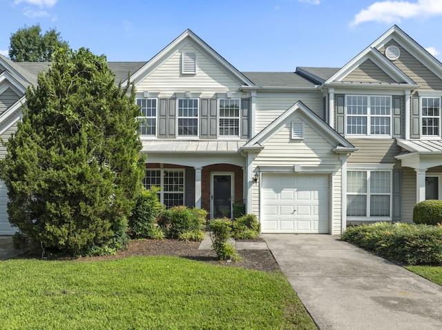 3405 Old Anderson Rd Unit 203, Antioch, TN 37013 - view of front of home with concrete driveway, a garage, a front yard, and a standing seam roof
