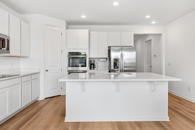 2337 Williamsport Lndg, Columbia, TN 38401 - kitchen with appliances with stainless steel finishes, a center island with sink, light wood-type flooring, light countertops, and recessed lighting