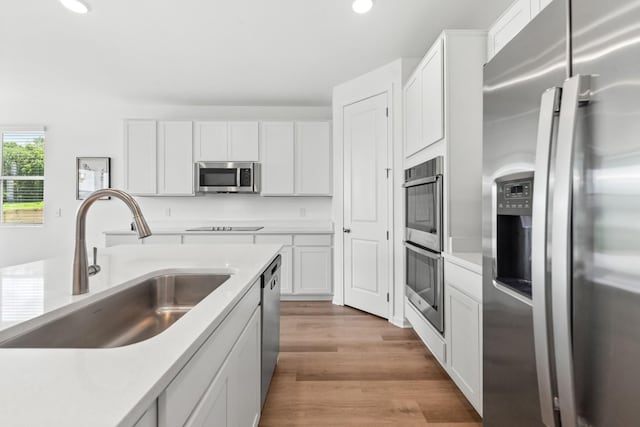 2337 Williamsport Lndg, Columbia, TN 38401 - kitchen featuring appliances with stainless steel finishes, recessed lighting, white cabinetry, light wood-type flooring, and light countertops