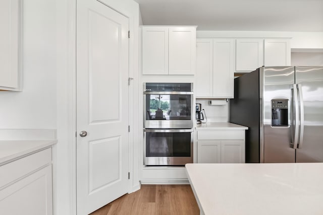 2337 Williamsport Lndg, Columbia, TN 38401 - kitchen featuring appliances with stainless steel finishes, white cabinetry, light countertops, and light wood finished floors