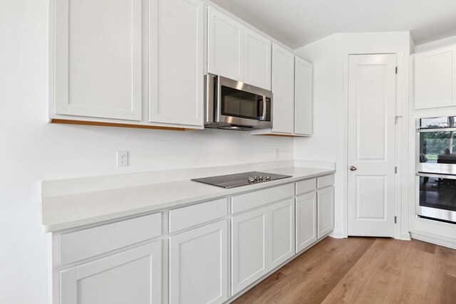 2337 Williamsport Lndg, Columbia, TN 38401 - kitchen featuring appliances with stainless steel finishes, light wood finished floors, white cabinetry, and light countertops