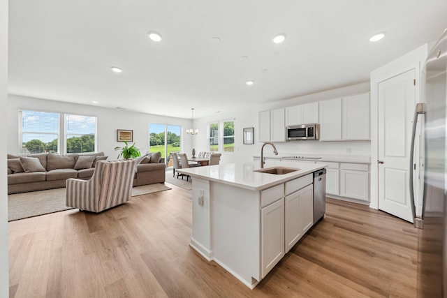 2337 Williamsport Lndg, Columbia, TN 38401 - kitchen featuring appliances with stainless steel finishes, light wood finished floors, white cabinets, light countertops, and open floor plan