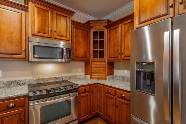 8146 Perfect Vw, Ooltewah, TN 37363 - kitchen with appliances with stainless steel finishes, brown cabinets, ornamental molding, and light stone counters