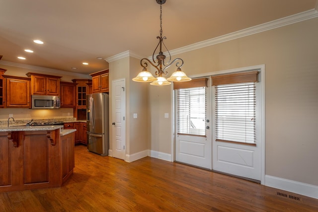 8146 Perfect Vw, Ooltewah, TN 37363 - kitchen featuring stainless steel appliances, brown cabinets, crown molding, a breakfast bar area, and glass insert cabinets