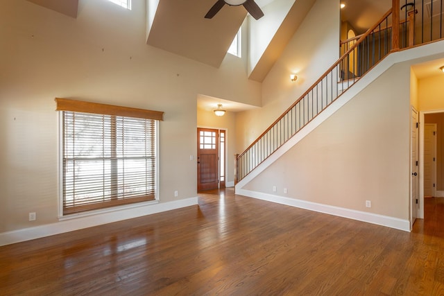 8146 Perfect Vw, Ooltewah, TN 37363 - unfurnished living room with a towering ceiling, a ceiling fan, stairway, and wood finished floors