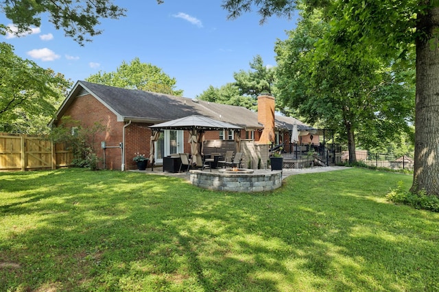 9505 Inavale Ln, Brentwood, TN 37027 - rear view of property with a gazebo, an outdoor fire pit, a fenced backyard, brick siding, and a patio area