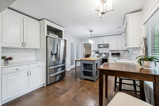 9505 Inavale Ln, Brentwood, TN 37027 - kitchen with stainless steel appliances, open shelves, under cabinet range hood, and butcher block countertops