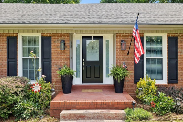 9505 Inavale Ln, Brentwood, TN 37027 - view of exterior entry with brick siding, a shingled roof, and covered porch