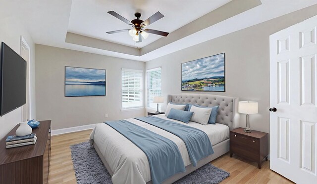 7313 Horn Tavern Ct, Fairview, TN 37062 - bedroom with a raised ceiling, light wood-style floors, and a ceiling fan