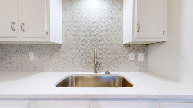 2104 W Richmond Hill Dr, Nashville, TN 37207 - kitchen featuring tasteful backsplash, white cabinets, and light stone counters