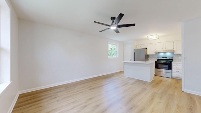 2104 W Richmond Hill Dr, Nashville, TN 37207 - kitchen with stainless steel appliances, light countertops, light wood finished floors, and under cabinet range hood