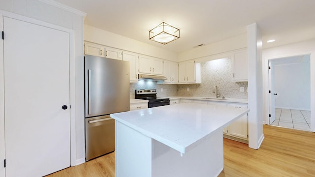 2104 W Richmond Hill Dr, Nashville, TN 37207 - kitchen featuring black range with electric cooktop, freestanding refrigerator, under cabinet range hood, light countertops, and backsplash