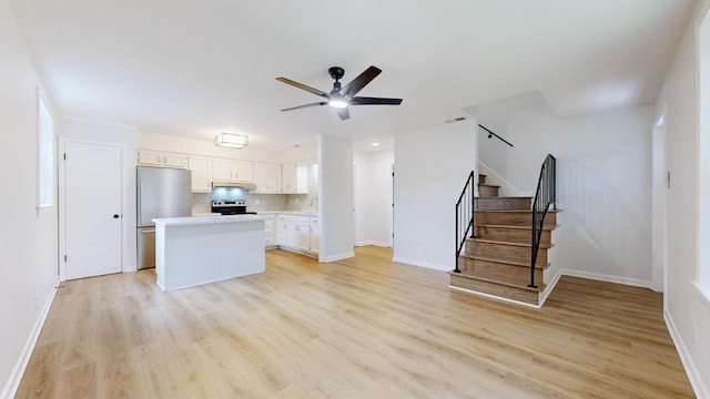 2104 W Richmond Hill Dr, Nashville, TN 37207 - unfurnished living room with ceiling fan, light wood-type flooring, and stairway