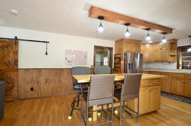 1355 Westfield Rd, Dickson, TN 37055 - kitchen with stainless steel fridge with ice dispenser, light wood-style flooring, backsplash, open shelves, and a textured ceiling