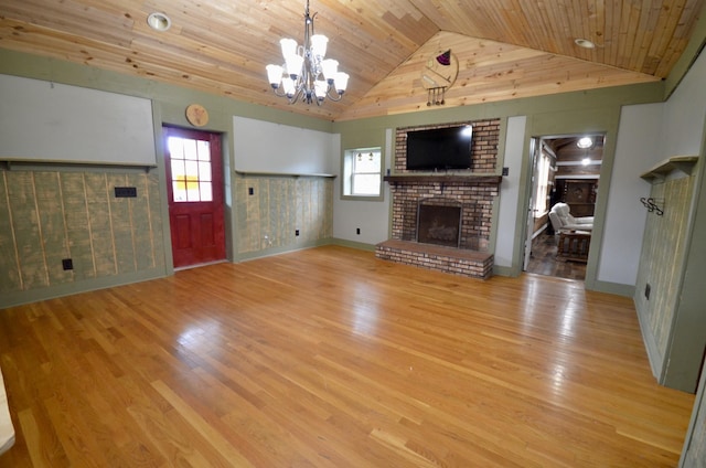 1355 Westfield Rd, Dickson, TN 37055 - unfurnished living room featuring a brick fireplace, light wood finished floors, a chandelier, wooden ceiling, and plenty of natural light