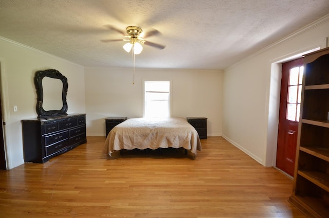 1355 Westfield Rd, Dickson, TN 37055 - bedroom featuring crown molding, light wood-style flooring, a textured ceiling, and a ceiling fan