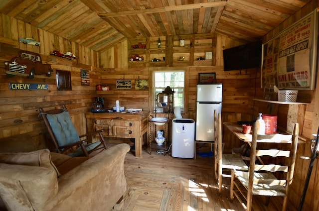 1355 Westfield Rd, Dickson, TN 37055 - kitchen with freestanding refrigerator, lofted ceiling, wooden walls, wood ceiling, and hardwood / wood-style flooring