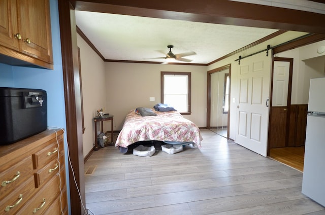 1355 Westfield Rd, Dickson, TN 37055 - bedroom featuring freestanding refrigerator, ornamental molding, a barn door, light wood-style floors, and a ceiling fan