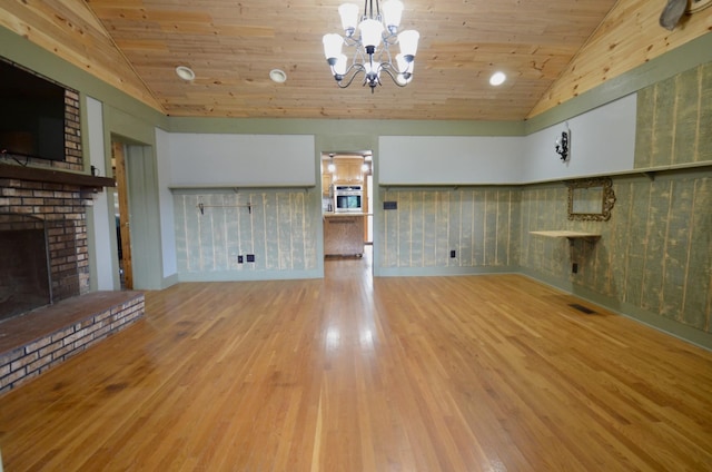 1355 Westfield Rd, Dickson, TN 37055 - unfurnished living room with lofted ceiling, wood ceiling, a brick fireplace, a chandelier, and wood finished floors