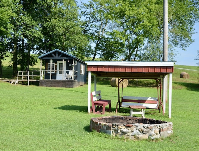 1355 Westfield Rd, Dickson, TN 37055 - view of grassy yard with an outdoor structure and a fire pit